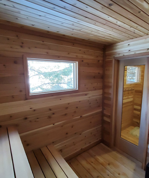 Interior view of outdoor sauna with change room and wood buring stove